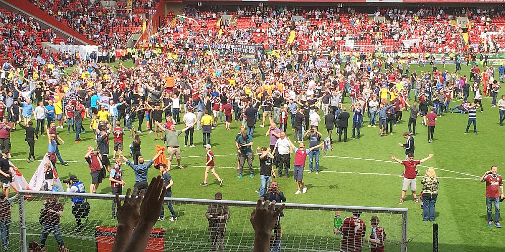 Burnley fans flood the pitch at Charlton after the title is won