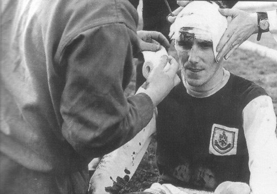 Les Latcham receives treatment from George Bray after a clash of heads with Altafini