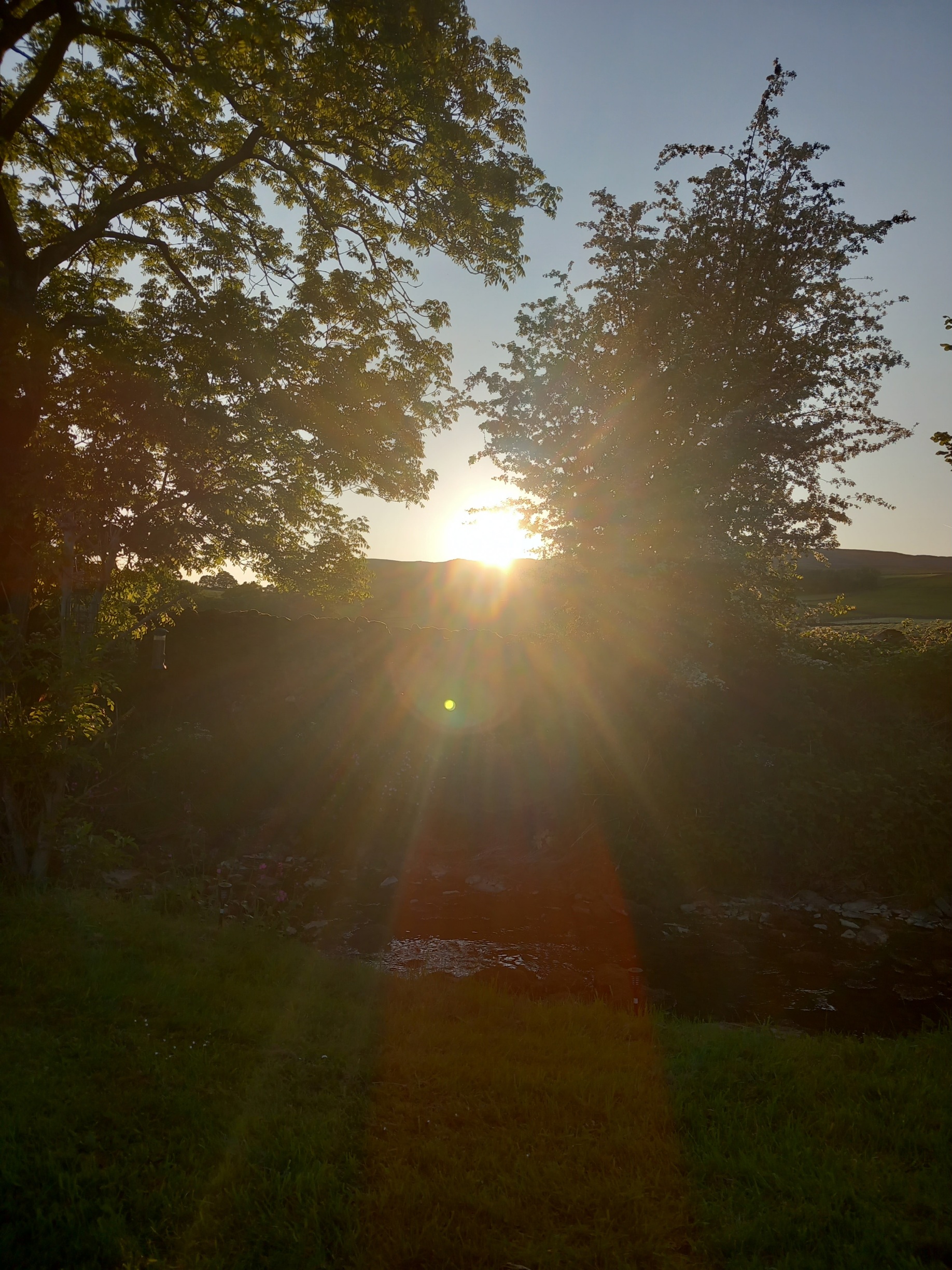 Austwick, N Yorkshire last weekend. Sunset peeping through the trees and a tiny hole in the wall....unless it's a spook