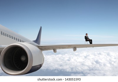 businessman-sitting-on-airplane-wings-260nw-143051593.jpg